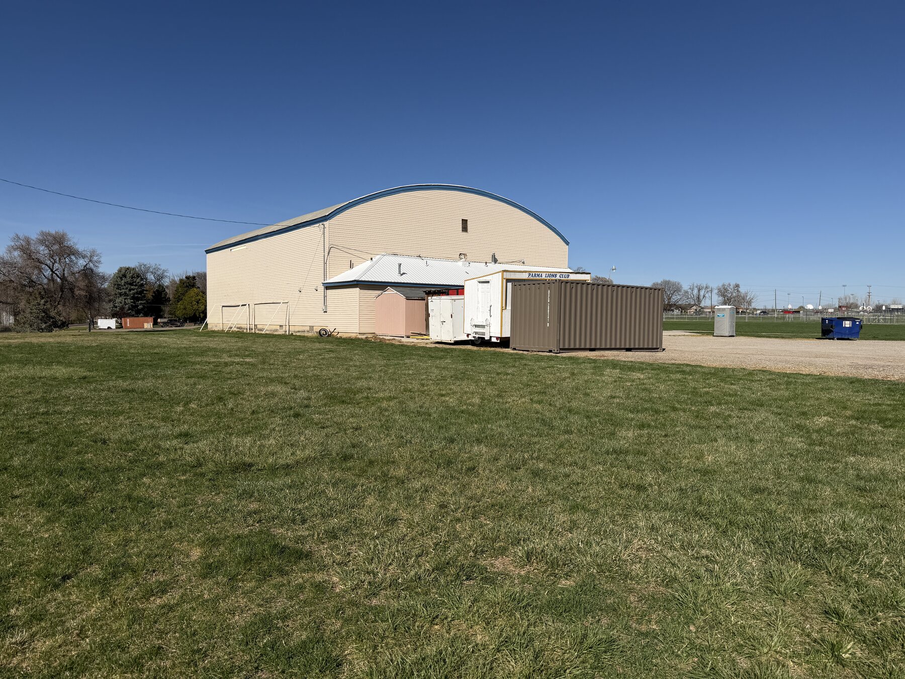 Broad view of the Yellow Barn Gymnasium showing its arched roof and lower attached section
